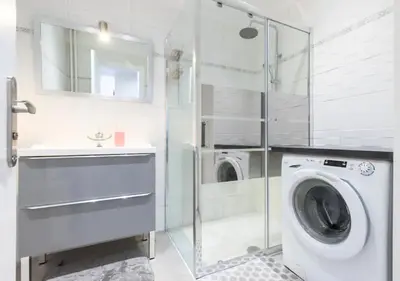 a bedroom with a bed with white sheets and a tv at Beautiful & spacious 2 bed Apt near Nice Center in Nice