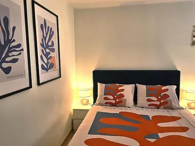 a bedroom with a bed with two lamps on it at Studio grande terrasse à 5 min de la mer in Nice