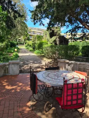 a table and chairs sitting on a brick patio at Studio grande terrasse à 5 min de la mer in Nice