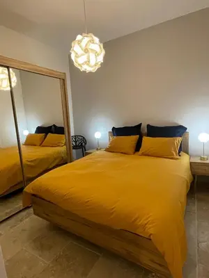 a bedroom with two beds and a large mirror at Vieux-Nice 3 pièces confortable et calme in Nice