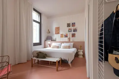 a white bedroom with a white bed and a window at SLO Hostel Nice in Nice