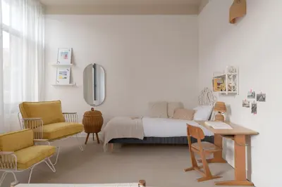 a bedroom with a bed and a table and chairs at SLO Hostel Nice in Nice