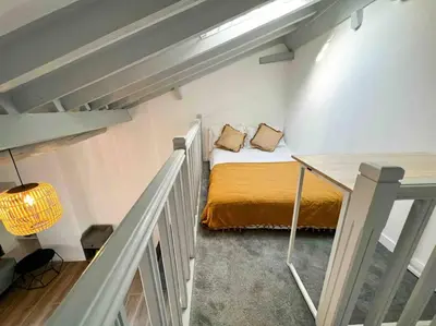 a small room with a bed and a table at Beautiful Top Floor & Terrasse (Beach 1' walk) in Nice
