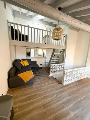 a living room with a couch and a staircase at Beautiful Top Floor & Terrasse (Beach 1' walk) in Nice