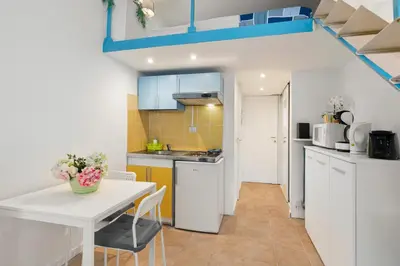 a kitchen with a white table and a white counter top at Studio Azur FSH in Nice