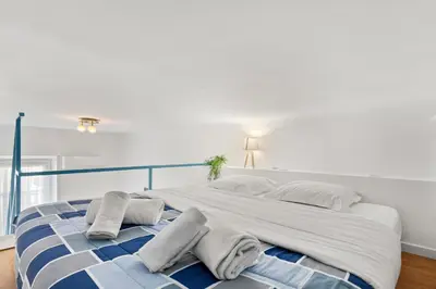 a large white bed with two pillows on it at Studio Azur FSH in Nice