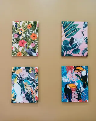 four pieces of art on a wall with birds and flowers at Studio Nicehome Massena in Nice