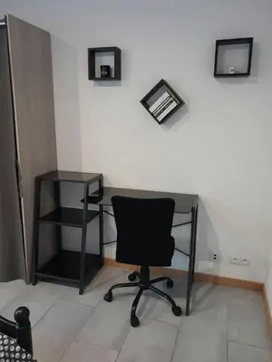 a desk and a chair in a room at Appartement spacieux &très calme. Spacious & very quiet apartment. in Carros