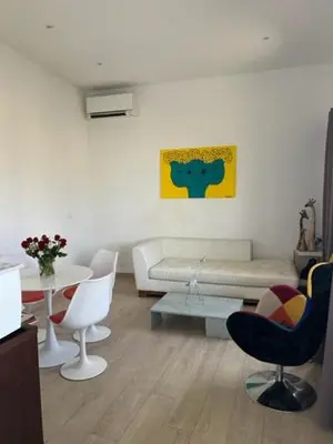 a living room with a couch and chairs and a table at Superbe appartement grande corniche vue sur mer Nice à 4 min du centre ville in Nice