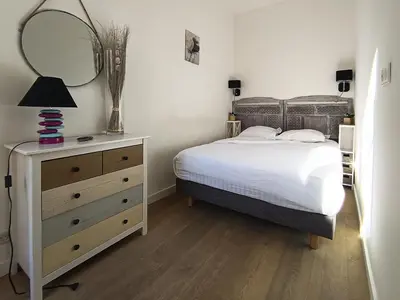 a bedroom with a bed and a dresser with a mirror at Superbe 2 pièces Carré d’or avec grande Terrasse in Nice