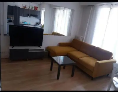 a living room with a couch and a flat screen tv at En plein coeur de Nice in Nice