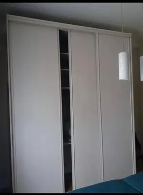 a white cabinet with a glass door in a room at En plein coeur de Nice in Nice