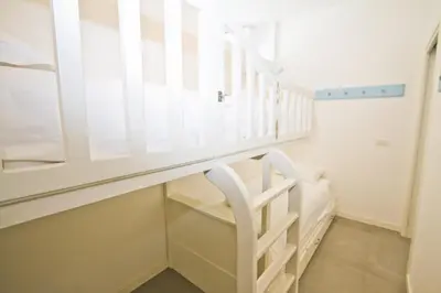 a white staircase in a room with a window at Garden Floor Condo with Promenade Sea View in Nice
