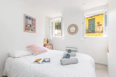a white bedroom with a bed and two windows at MY CASA - MALONAT - Cosy Apart in Old Town w AC in Nice