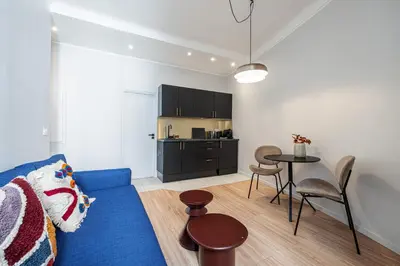 a living room with a blue couch and a table at Coeur de La Libé - Ideal couple & FRIENDS - CENTRAL & COSY - TRAM & Supermarkets -AC -Bed XXL in Nice