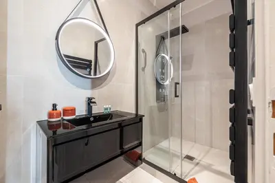 a bathroom with a sink and a mirror at Coeur de La Libé - Ideal couple & FRIENDS - CENTRAL & COSY - TRAM & Supermarkets -AC -Bed XXL in Nice
