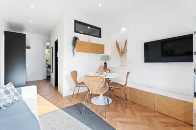 a living room with a table and chairs at Nice Renting - MAETERLINCK - Idyllic Luxury Retreat in Cap de Nice Sea View in Nice