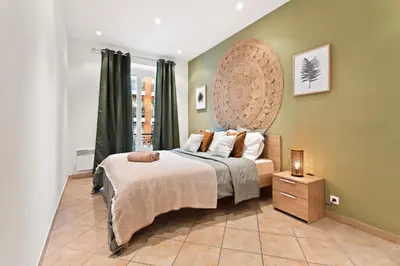 a bedroom with a bed with a large headboard at Nice - Renting - LASCARIS - Charm & Spacious & Comfort 3P Port Bonaparte in Nice