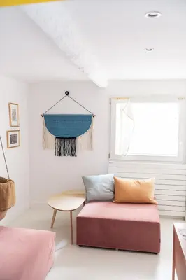 a living room with a couch and a window at Duplex au cœur du vieux Nice in Nice