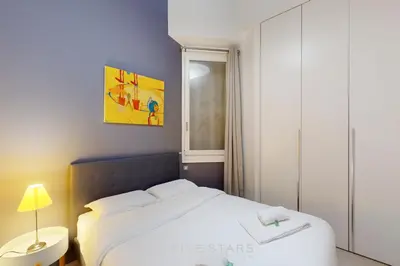 a bedroom with a white bed and a window at Loft Gambetta 33 Fshh in Nice