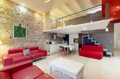 a living room with red furniture and a staircase at Loft Gambetta 33 Fshh in Nice