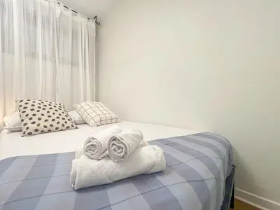 a bedroom with two rolled towels on a bed at Le Baccarat - Wifi, AC, vue mer, 4 pers in Nice