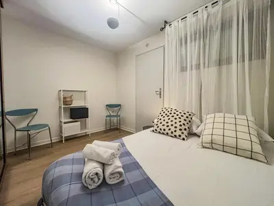 a bedroom with a bed with towels on it at Le Baccarat - Wifi, AC, vue mer, 4 pers in Nice