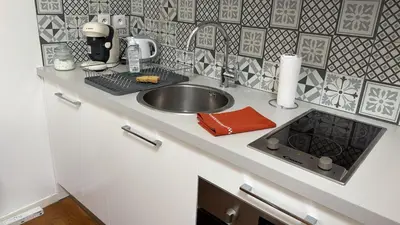 a kitchen counter with a sink and a mixer at Appartement T2 coconing, WIFI, INTERNET, CLIM, 300m plage in Nice