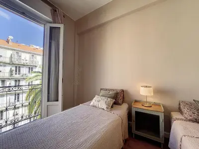 a bedroom with two beds and a large window at Nestor&Jeeves - BELLE EPOQUE - Central, Close sea in Nice