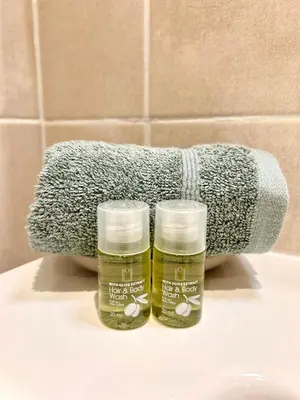 two bottles of mouthwash sitting on a sink in a bathroom at Appartement neuf coup de coeur entre Èze et Monaco in Èze
