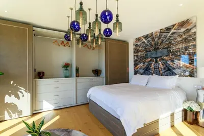 a bedroom with a bed and a painting on the wall at Luxury Villa Nice in Nice