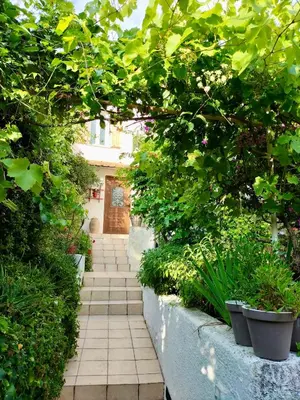 a garden path with plants and a wooden door at Villa Bellabé in Nice