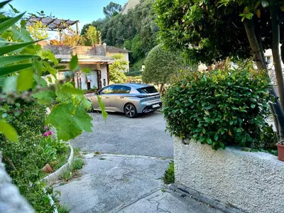 a car parked in the driveway of a house at Villa Bellabé in Nice
