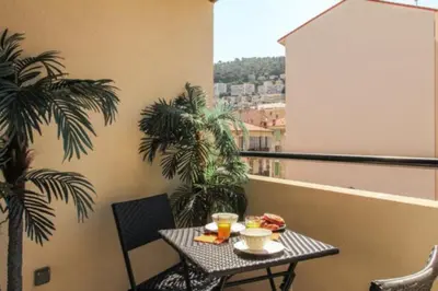 a balcony with a table with food on it at Villa Tobias in Nice