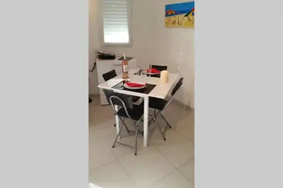 a kitchen with a white table and chairs at Villa Tobias in Nice