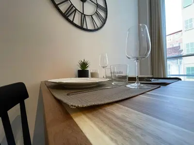 a table with two glasses and a clock on the wall at Charmant Studio - Port de Nice in Nice