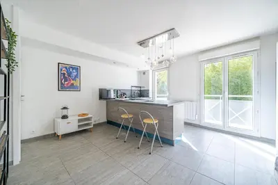 a kitchen with a counter and two stools at Le calme à Nissa la Bella in Nice