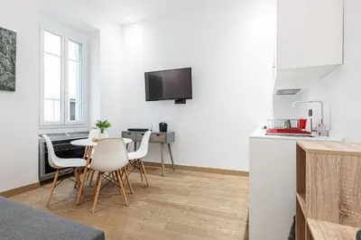 a kitchen and dining room with a table and chairs at Garibaldi Square - Cozy 1 Bdr Old Town in Nice