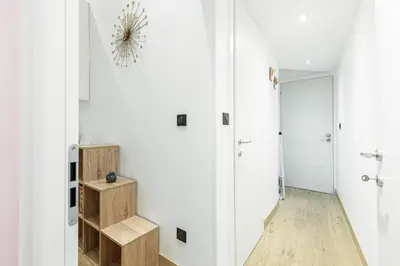 a room with a hallway with white walls and wooden floors at Garibaldi Square - Cozy 1 Bdr Old Town in Nice