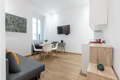 a living room with a couch and a table at Garibaldi Square - Cozy 1 Bdr Old Town in Nice