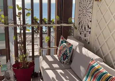 a white couch on a balcony with a view of the ocean at 2Bed 2Bath Sea View Promenade Bright & Spacious! BRAVOSTAYSRIVERIA in Nice