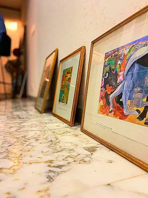 a row of framed paintings on a wall at Côte d'Azur Oasis Suites in Nice