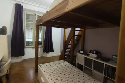 a bedroom with two bunk beds and a staircase at Spacieux 4 pièces de type bourgeois Art-déco in Nice