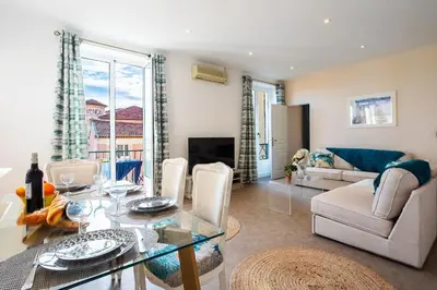 a living room with a glass table and a couch at LE PROVENCE AP4389 By Riviera Holiday Homes in Villefranche-sur-Mer