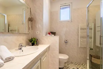 a bathroom with a sink and a toilet and a mirror at LE PROVENCE AP4389 By Riviera Holiday Homes in Villefranche-sur-Mer