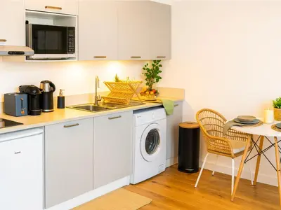 a kitchen with a washing machine and a table at Modern apartment with AC near Old Nice & Beach in Nice