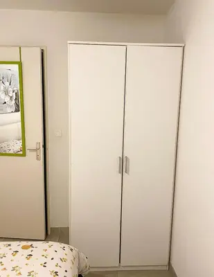 a bedroom with white cabinets and a bed at bellissimo appartamento in Nice