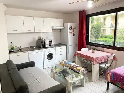 a living room with a couch and a table in a kitchen at bellissimo appartamento in Nice