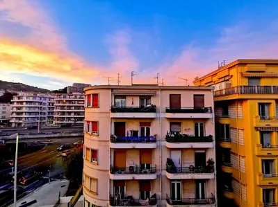 a view of a building in a city at sunset at Studio cosy - Proche mer et gare in Nice