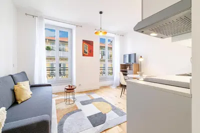 a living room with a couch and a kitchen at Charming City Center Studio 406 in Nice